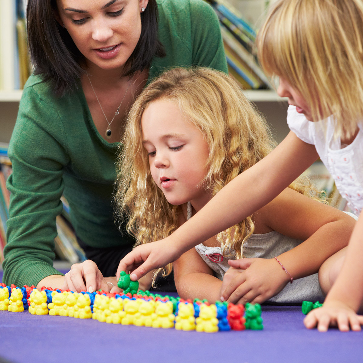 Elementary,Pupils,Counting,With,Teacher,In,Classroom