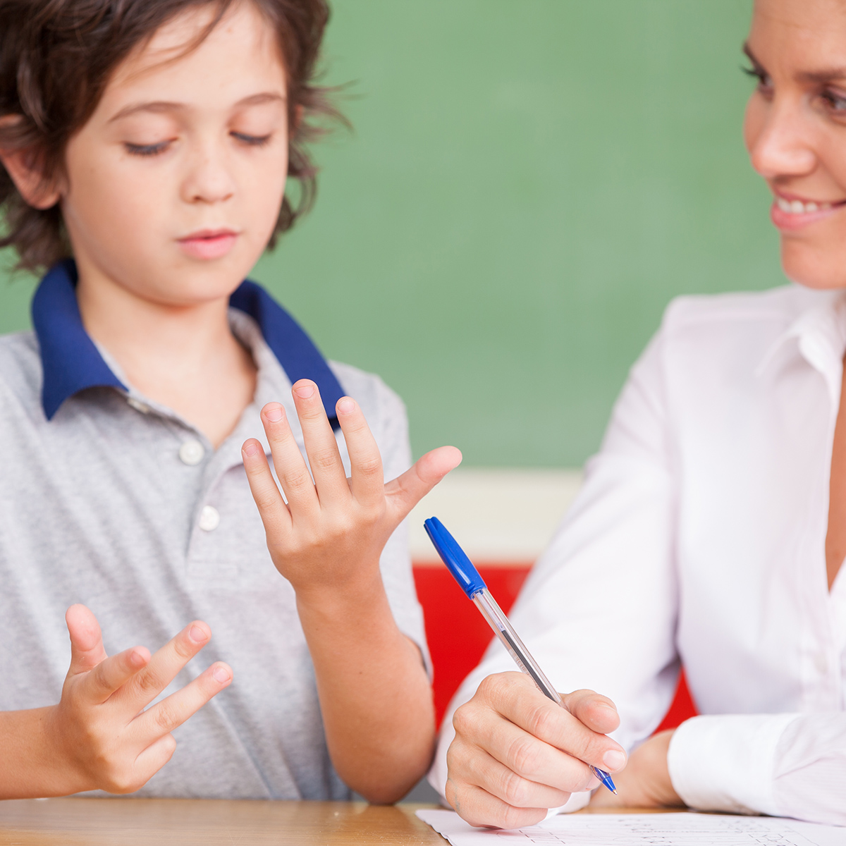 Hand,Of,Kid,Learning,Math,With,Teacher.